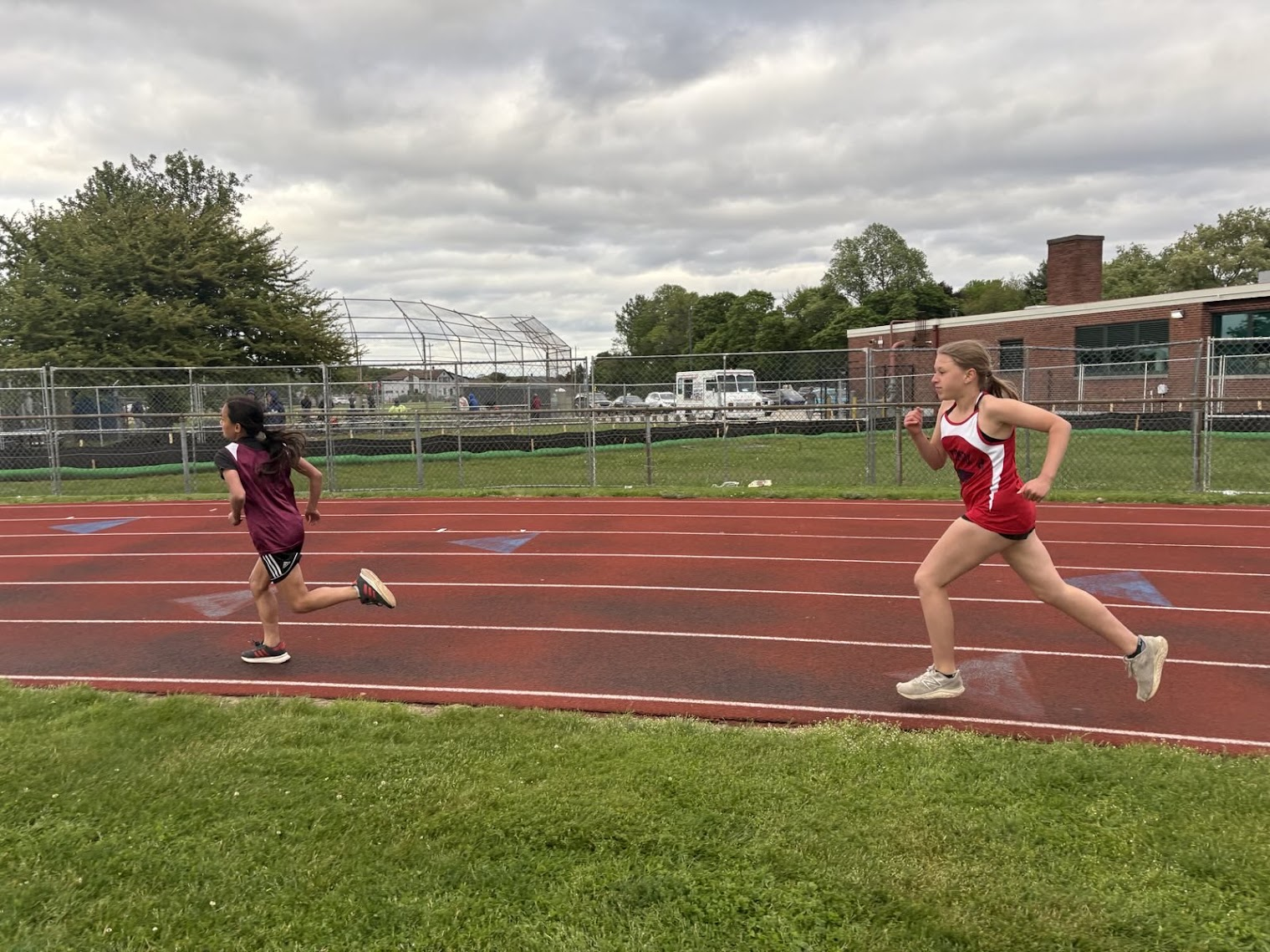 Eva racing another runner on the track